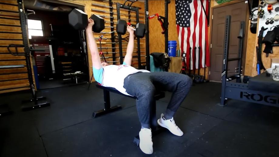 Man performing bench press on the Amazon Basics Flat Weight Bench