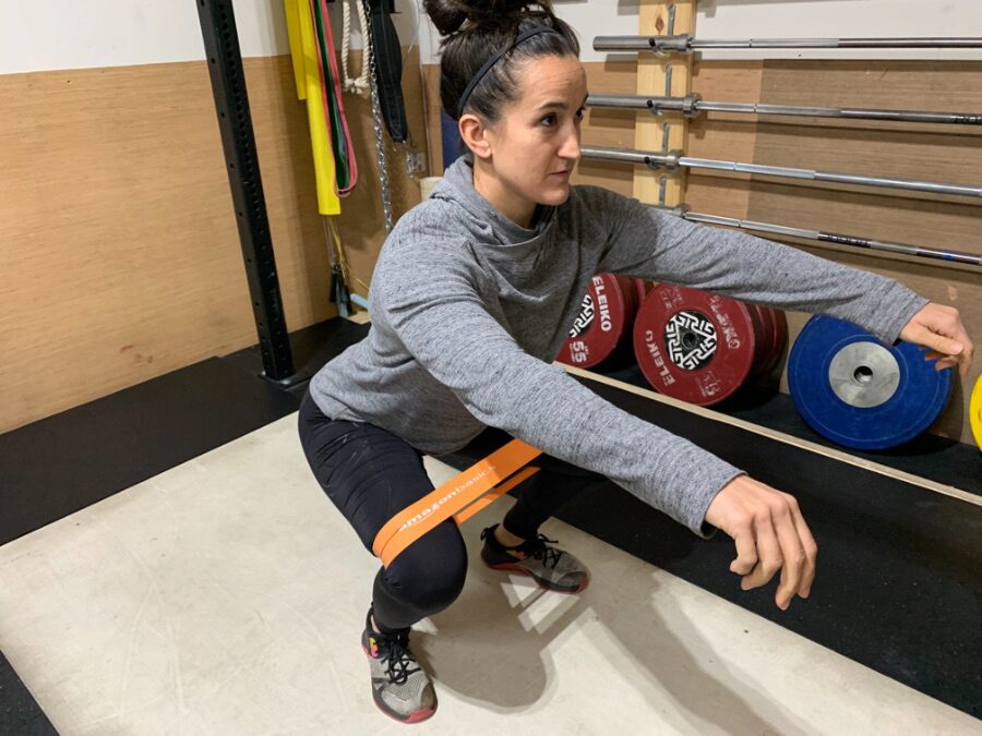 Woman squatting with an AmazonBasics Resistance Band