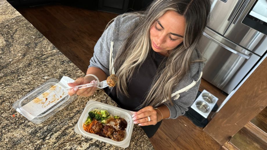 Woman eating a meal from Snap Kitchen